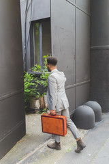 young black business man walking to work outdoor - business, working, job concept