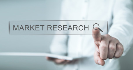 Man touching on Market Research search button. Web search concept