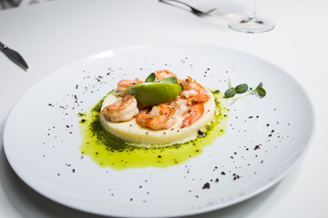 Shrimp with lime on a white plate close-up