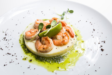Shrimp with lime on a white plate close-up