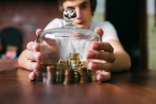 Crop hands covering coins with lid