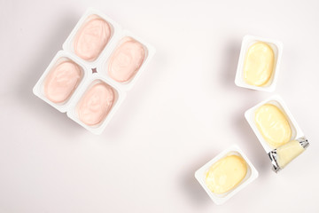 Plastic cup with tasty yogurt isolated on white. Top view. Space for text or design.