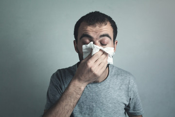 Man blowing his nose. Healthy medicine concept