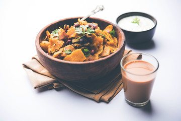 Homemade Kothu Parotta/ Paratha or Stir Fried Leftover Chapati Masala or  fodnichi poli in marathi, served in a bowl or plate with curd and hot tea. Selective focus