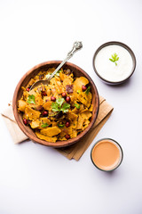 Homemade Kothu Parotta/ Paratha or Stir Fried Leftover Chapati Masala or  fodnichi poli in marathi, served in a bowl or plate with curd and hot tea. Selective focus