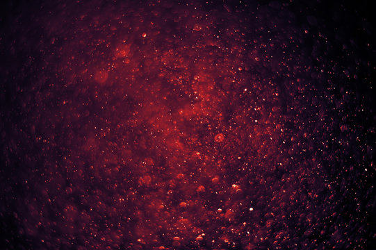 Light and flare in red tones bokeh abstract background.
