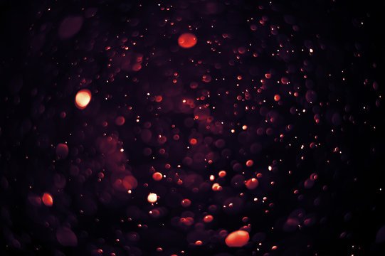 Light and flare in red tones bokeh abstract background.