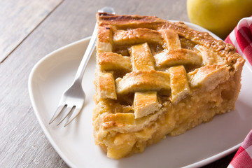 Homemade apple pie slice on wooden table
