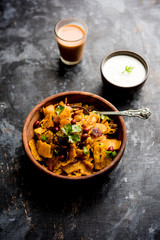 Homemade Kothu Parotta/ Paratha or Stir Fried Leftover Chapati Masala or  fodnichi poli in marathi, served in a bowl or plate with curd and hot tea. Selective focus