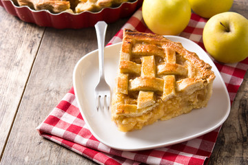 Homemade apple pie slice on wooden table