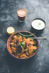 Homemade Kothu Parotta/ Paratha or Stir Fried Leftover Chapati Masala or  fodnichi poli in marathi, served in a bowl or plate with curd and hot tea. Selective focus