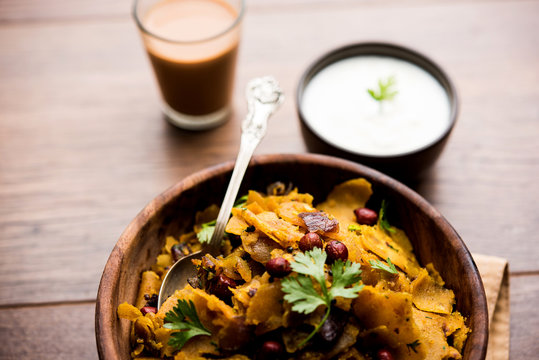 Homemade Kothu Parotta/ Paratha or Stir Fried Leftover Chapati Masala or  fodnichi poli in marathi, served in a bowl or plate with curd and hot tea. Selective focus