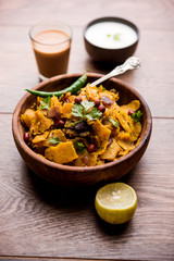 Homemade Kothu Parotta/ Paratha or Stir Fried Leftover Chapati Masala or  fodnichi poli in marathi, served in a bowl or plate with curd and hot tea. Selective focus