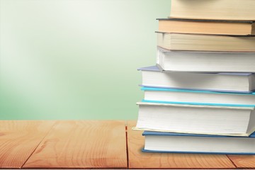 Stack of colorful books on blurred background