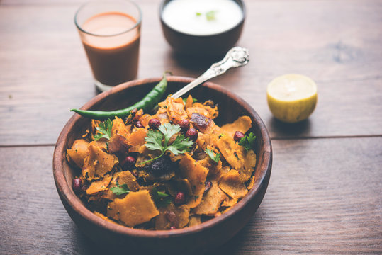 Homemade Kothu Parotta/ Paratha or Stir Fried Leftover Chapati Masala or  fodnichi poli in marathi, served in a bowl or plate with curd and hot tea. Selective focus