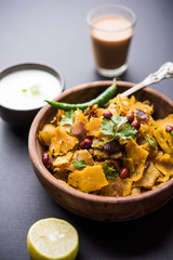Homemade Kothu Parotta/ Paratha or Stir Fried Leftover Chapati Masala or  fodnichi poli in marathi, served in a bowl or plate with curd and hot tea. Selective focus