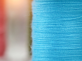 blurry light design background of blue thread on background,needlework,craft,sewing and tailoring concept