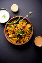 Homemade Kothu Parotta/ Paratha or Stir Fried Leftover Chapati Masala or  fodnichi poli in marathi, served in a bowl or plate with curd and hot tea. Selective focus