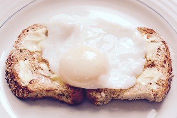 Poached egg on buttered brown toast, filter applied   