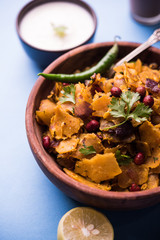 Homemade Kothu Parotta/ Paratha or Stir Fried Leftover Chapati Masala or  fodnichi poli in marathi, served in a bowl or plate with curd and hot tea. Selective focus