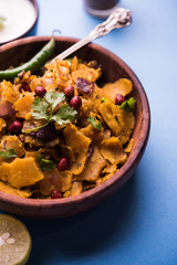 Homemade Kothu Parotta/ Paratha or Stir Fried Leftover Chapati Masala or  fodnichi poli in marathi, served in a bowl or plate with curd and hot tea. Selective focus
