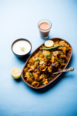 Homemade Kothu Parotta/ Paratha or Stir Fried Leftover Chapati Masala or  fodnichi poli in marathi, served in a bowl or plate with curd and hot tea. Selective focus