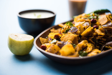 Homemade Kothu Parotta/ Paratha or Stir Fried Leftover Chapati Masala or  fodnichi poli in marathi, served in a bowl or plate with curd and hot tea. Selective focus
