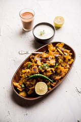 Homemade Kothu Parotta/ Paratha or Stir Fried Leftover Chapati Masala or  fodnichi poli in marathi, served in a bowl or plate with curd and hot tea. Selective focus