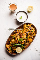 Homemade Kothu Parotta/ Paratha or Stir Fried Leftover Chapati Masala or  fodnichi poli in marathi, served in a bowl or plate with curd and hot tea. Selective focus