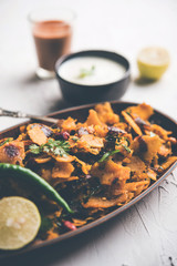 Homemade Kothu Parotta/ Paratha or Stir Fried Leftover Chapati Masala or  fodnichi poli in marathi, served in a bowl or plate with curd and hot tea. Selective focus