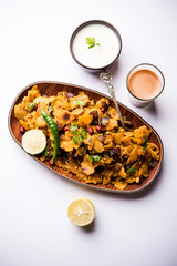 Homemade Kothu Parotta/ Paratha or Stir Fried Leftover Chapati Masala or  fodnichi poli in marathi, served in a bowl or plate with curd and hot tea. Selective focus