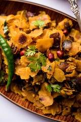 Fototapeta premium Homemade Kothu Parotta/ Paratha or Stir Fried Leftover Chapati Masala or fodnichi poli in marathi, served in a bowl or plate with curd and hot tea. Selective focus