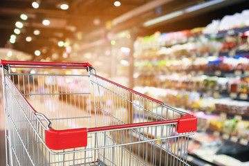 supermarket grocery store with fruit and vegetable shelves interior defocused background with empty...
