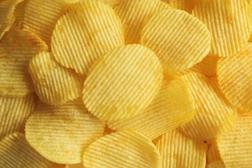 crispy potato chips snack texture background closeup top view