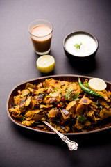 Homemade Kothu Parotta/ Paratha or Stir Fried Leftover Chapati Masala or  fodnichi poli in marathi, served in a bowl or plate with curd and hot tea. Selective focus