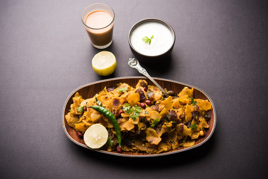 Homemade Kothu Parotta/ Paratha or Stir Fried Leftover Chapati Masala or  fodnichi poli in marathi, served in a bowl or plate with curd and hot tea. Selective focus