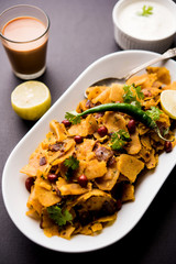 Homemade Kothu Parotta/ Paratha or Stir Fried Leftover Chapati Masala or  fodnichi poli in marathi, served in a bowl or plate with curd and hot tea. Selective focus