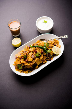 Homemade Kothu Parotta/ Paratha or Stir Fried Leftover Chapati Masala or  fodnichi poli in marathi, served in a bowl or plate with curd and hot tea. Selective focus