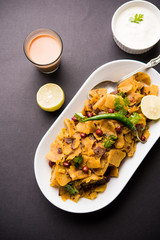 Homemade Kothu Parotta/ Paratha or Stir Fried Leftover Chapati Masala or  fodnichi poli in marathi, served in a bowl or plate with curd and hot tea. Selective focus
