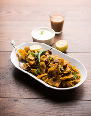 Homemade Kothu Parotta/ Paratha or Stir Fried Leftover Chapati Masala or  fodnichi poli in marathi, served in a bowl or plate with curd and hot tea. Selective focus