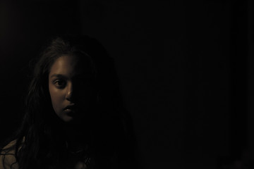 portrait of a young woman in dark