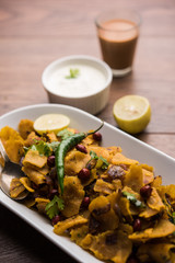 Homemade Kothu Parotta/ Paratha or Stir Fried Leftover Chapati Masala or  fodnichi poli in marathi, served in a bowl or plate with curd and hot tea. Selective focus