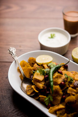 Homemade Kothu Parotta/ Paratha or Stir Fried Leftover Chapati Masala or  fodnichi poli in marathi, served in a bowl or plate with curd and hot tea. Selective focus