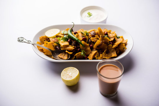 Homemade Kothu Parotta/ Paratha or Stir Fried Leftover Chapati Masala or  fodnichi poli in marathi, served in a bowl or plate with curd and hot tea. Selective focus