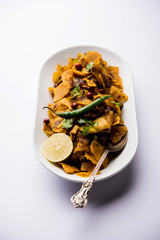 Homemade Kothu Parotta/ Paratha or Stir Fried Leftover Chapati Masala or  fodnichi poli in marathi, served in a bowl or plate with curd and hot tea. Selective focus