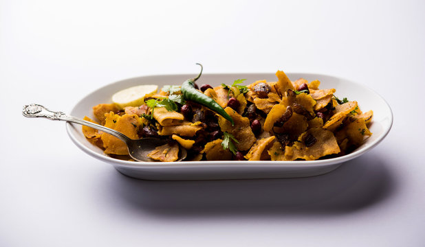 Homemade Kothu Parotta/ Paratha or Stir Fried Leftover Chapati Masala or  fodnichi poli in marathi, served in a bowl or plate with curd and hot tea. Selective focus