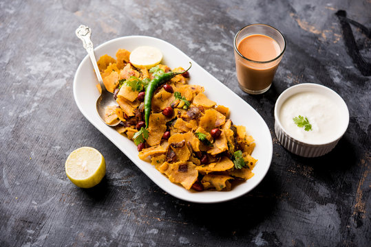Homemade Kothu Parotta/ Paratha or Stir Fried Leftover Chapati Masala or  fodnichi poli in marathi, served in a bowl or plate with curd and hot tea. Selective focus
