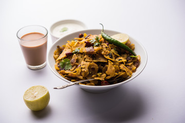 Homemade Kothu Parotta/ Paratha or Stir Fried Leftover Chapati Masala or  fodnichi poli in marathi, served in a bowl or plate with curd and hot tea. Selective focus