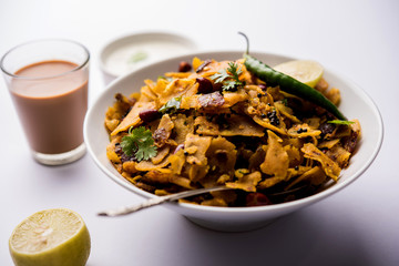 Homemade Kothu Parotta/ Paratha or Stir Fried Leftover Chapati Masala or  fodnichi poli in marathi, served in a bowl or plate with curd and hot tea. Selective focus