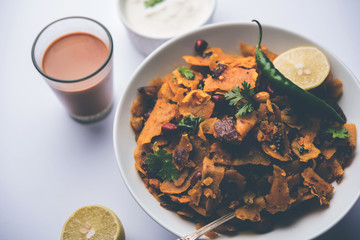 Homemade Kothu Parotta/ Paratha or Stir Fried Leftover Chapati Masala or  fodnichi poli in marathi, served in a bowl or plate with curd and hot tea. Selective focus
